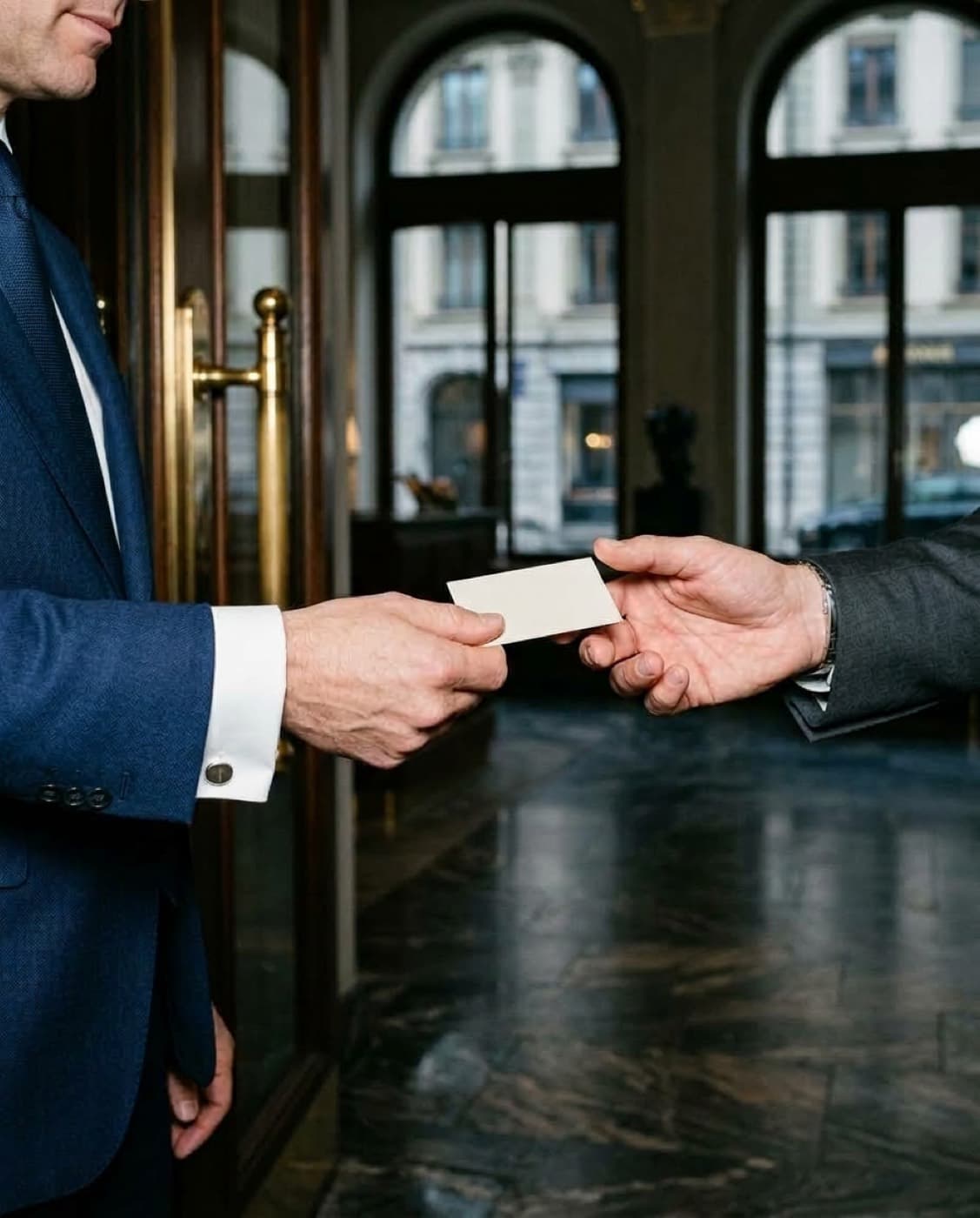A business card passed between two professionals